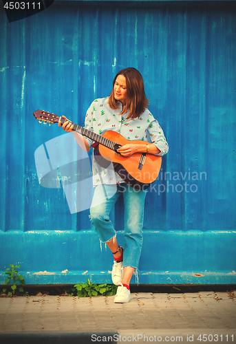 Image of Beautiful middle aged woman with a guitar