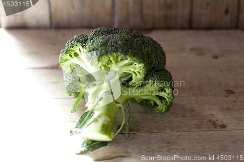 Image of Fresh green organic broccoli on wooden rustic background.