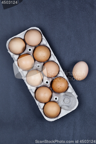 Image of Farm chicken eggs in cardboard container.