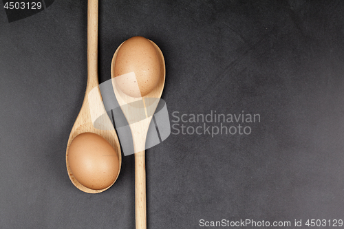 Image of Eggs in wooden spoons. Kitchen utensil for cake, pastry or cooki