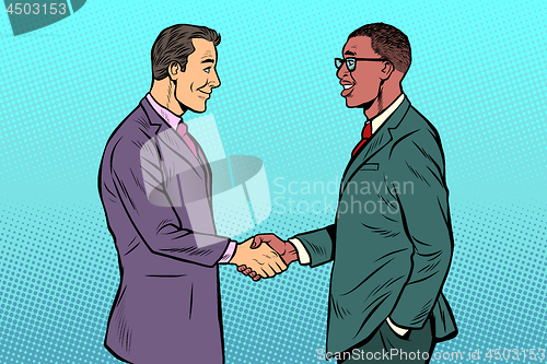 Image of African and Caucasian businessmen men handshake