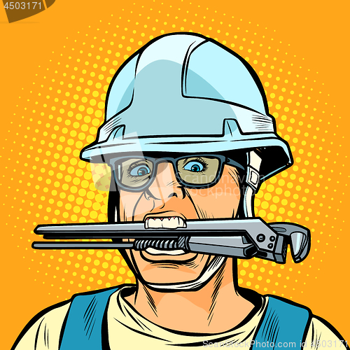 Image of funny working professional plumber with a wrench