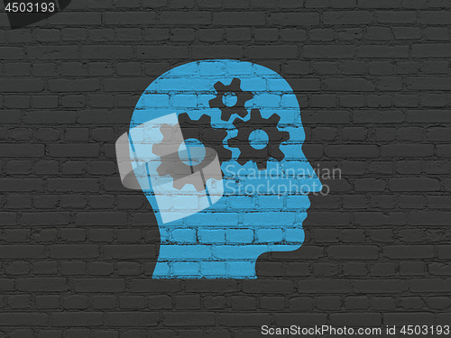 Image of Advertising concept: Head With Gears on wall background