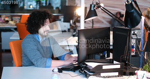 Image of businessman working using a computer in startup office