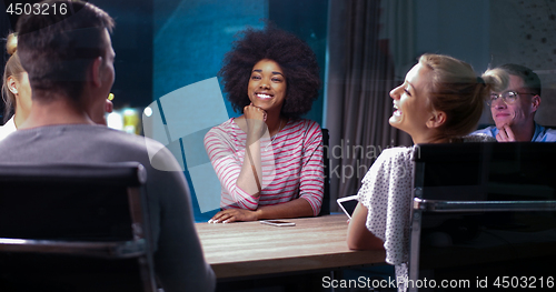 Image of Multiethnic startup business team in night office