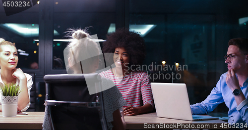 Image of Multiethnic startup business team in night office