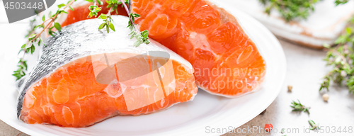 Image of Fresh raw salmon fish steaks on white kitchen background. Banner