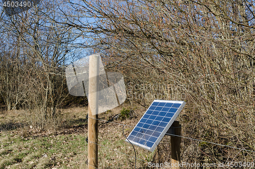 Image of Solar panel by a fence