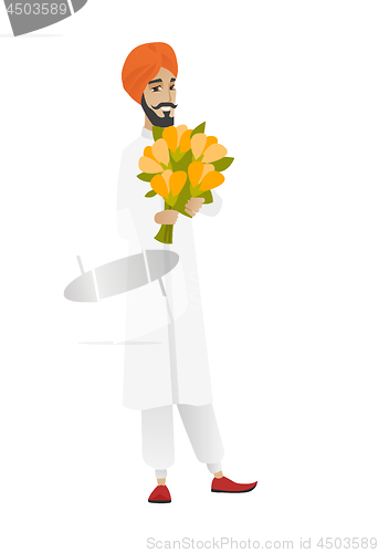 Image of Hindu businessman holding bouquet of flowers.