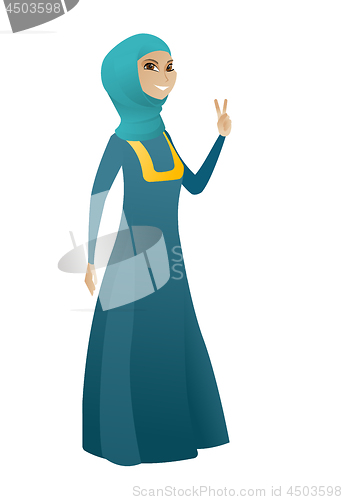 Image of Muslim business woman showing victory gesture.
