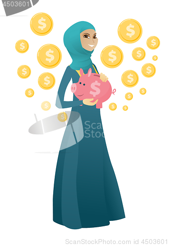 Image of Muslim business woman holding a piggy bank.