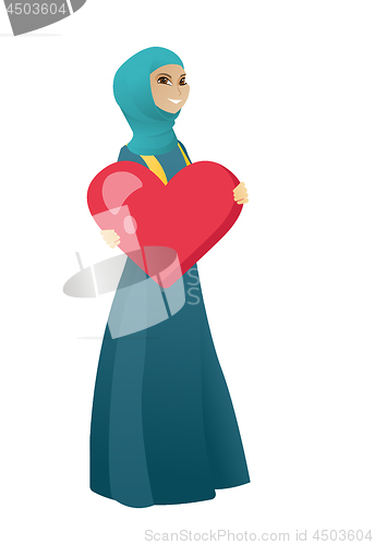 Image of Muslim business woman holding a big red heart.