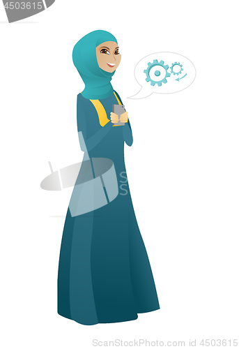 Image of Muslim business woman holding a mobile phone.