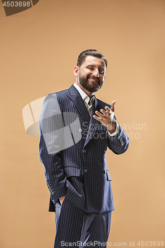 Image of The happy business man standing and smiling against pastel background.