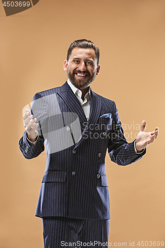 Image of The happy business man standing and smiling against pastel background.