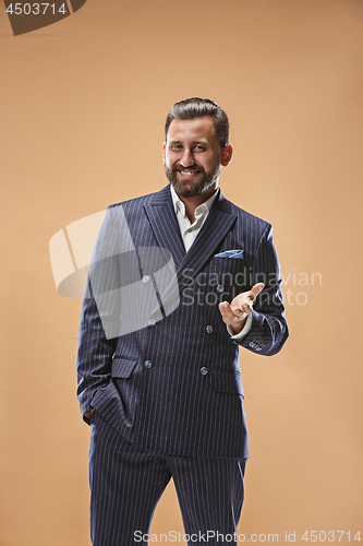 Image of The happy business man standing and smiling against pastel background.