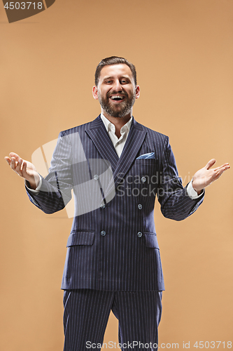 Image of The happy business man standing and smiling against pastel background.