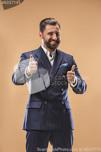 Image of The happy business man standing and smiling against pastel background.