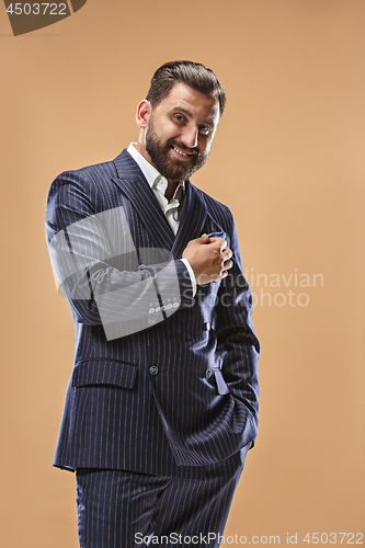 Image of The happy business man standing and smiling against pastel background.