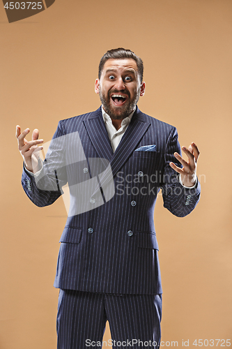 Image of The young attractive man looking suprised isolated on pastel