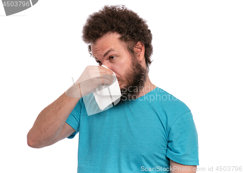 Image of Crazy bearded man has runny nose