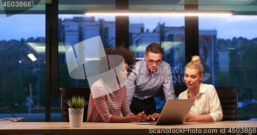 Image of Multiethnic startup business team in night office