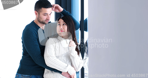 Image of multiethnic couple relaxing at modern home indoors