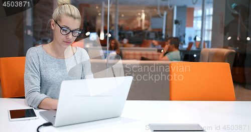 Image of businesswoman using a laptop in startup office