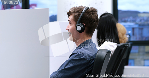 Image of male call centre operator doing his job