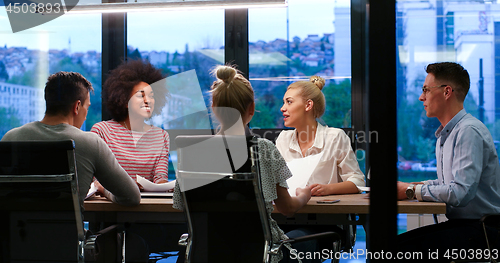 Image of Multiethnic startup business team in night office
