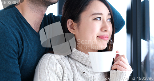 Image of multiethnic couple relaxing at modern home indoors