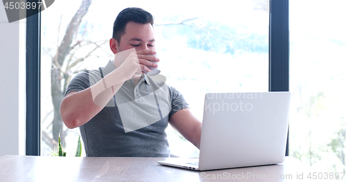 Image of businessman working using a laptop in startup office