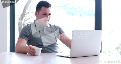 Image of businessman working using a laptop in startup office