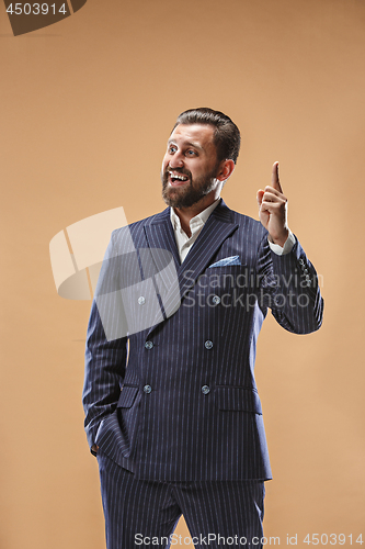 Image of Beautiful male half-length portrait isolated onpastel studio backgroud. The young emotional surprised man