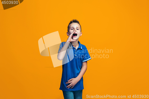 Image of Isolated on orange young casual teen boy shouting at studio