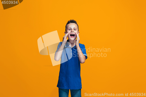 Image of Isolated on orange young casual teen boy shouting at studio