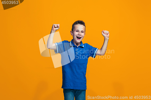 Image of Happy success teen boy celebrating being a winner. Dynamic energetic image of female model