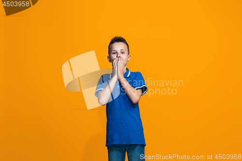 Image of Beautiful teen boyl looking suprised isolated on orange