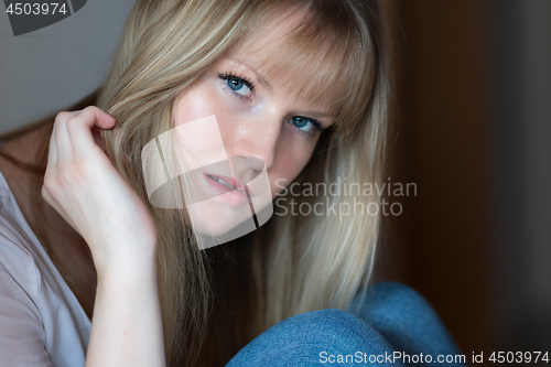 Image of Sad girl is sitting on the floor