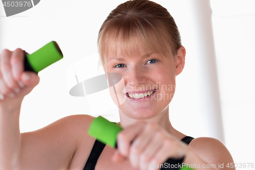 Image of Girl doing dumbbell exercises