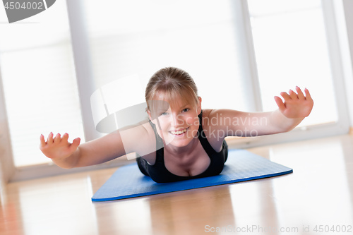 Image of Girl does exercise to strengthen her back