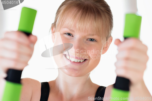 Image of Girl doing dumbbell exercises