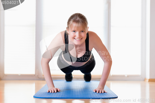 Image of Girl doing pushups exercises