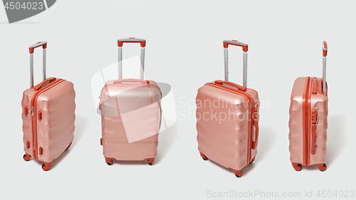 Image of Set of modern brown travel suitcases presented on a gray background with copy space. Tourism concept.