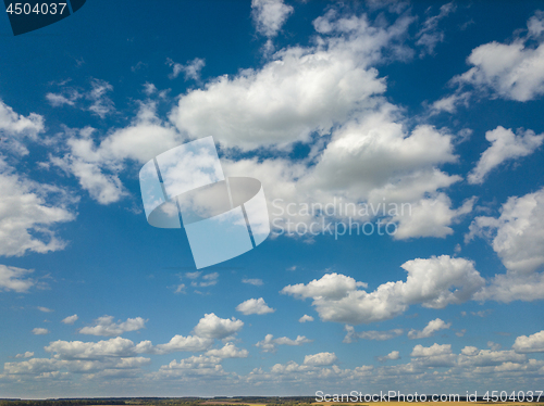 Image of Cloudy aerial landscape with white clouds on a blue sky background. Aerial view from drone.