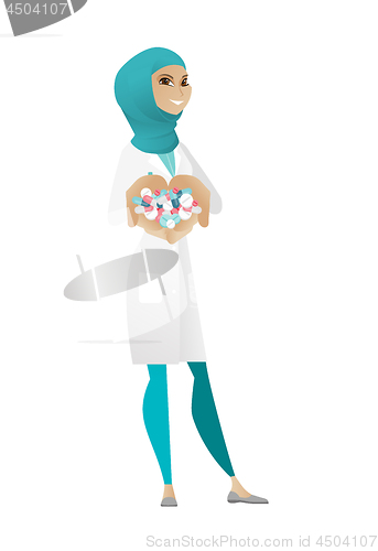 Image of Young muslim pharmacist giving pills.