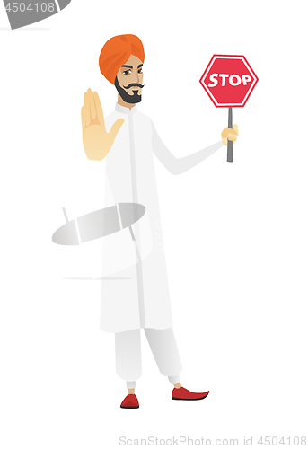 Image of Hindu businessman holding stop road sign.