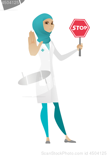 Image of Muslim doctor holding stop road sign.