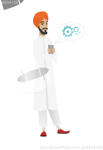 Image of Hindu businessman holding a mobile phone.