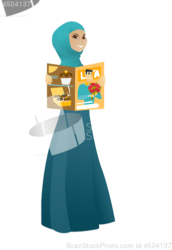 Image of Successful muslim business woman reading magazine.